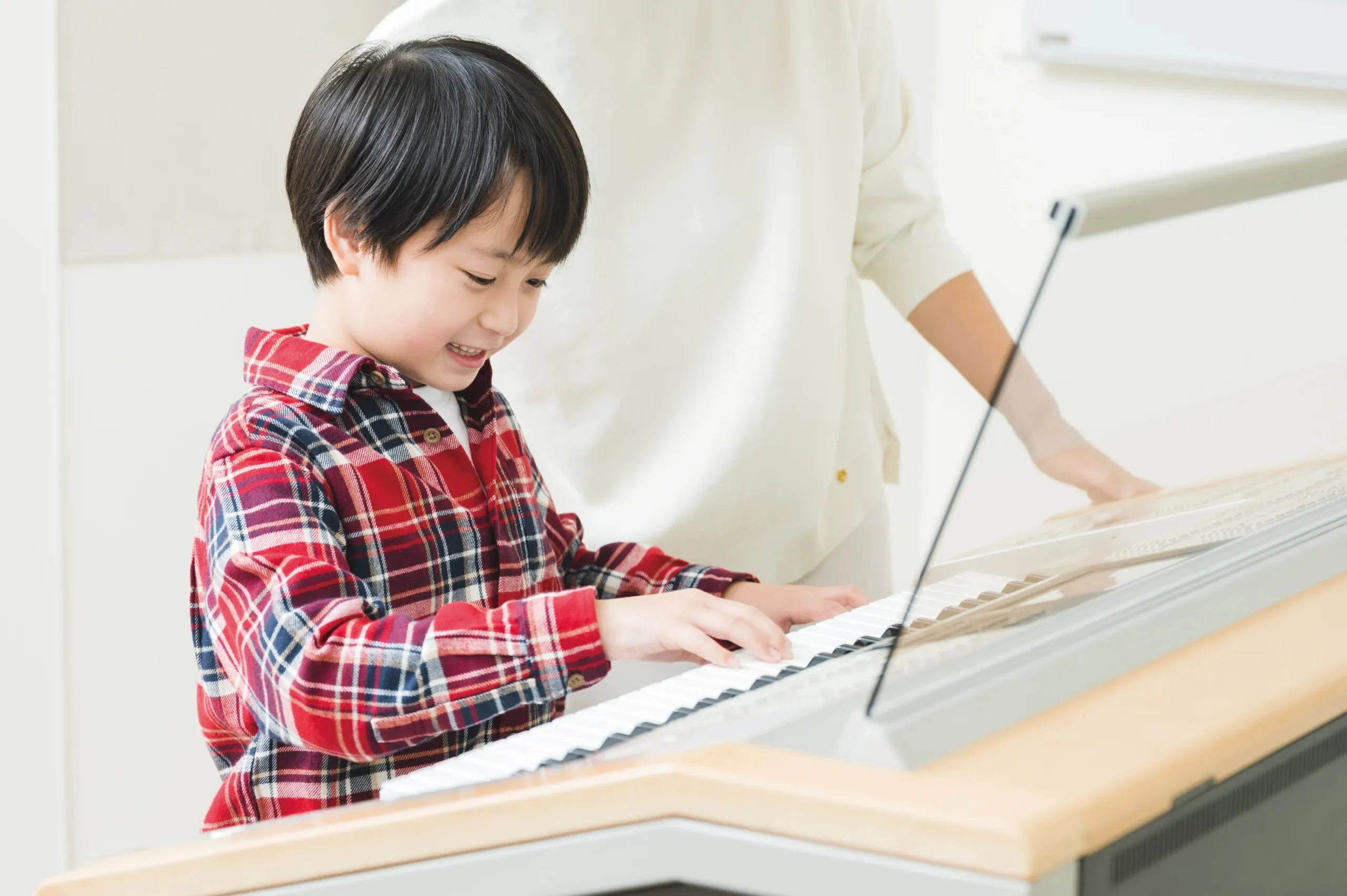 A young boy playing a keyboard in class