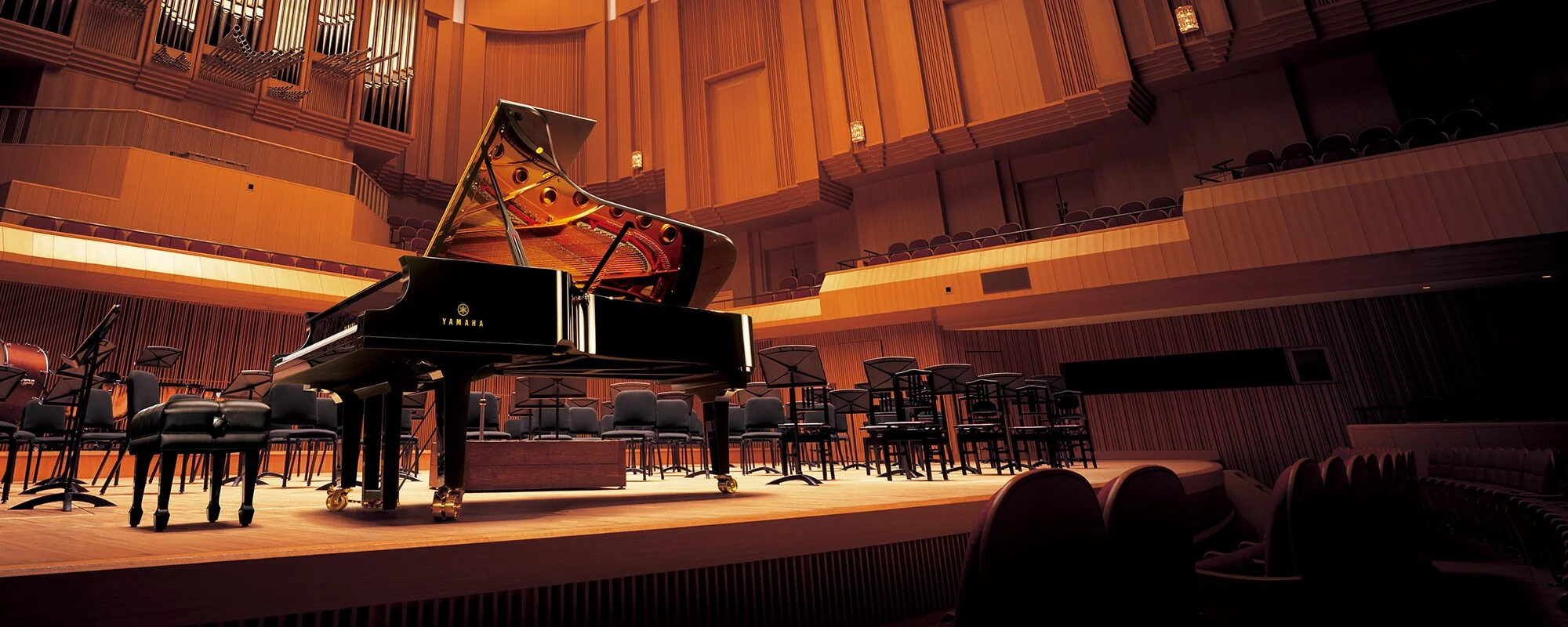 A Yamaha grand piano on a concert-hall stage